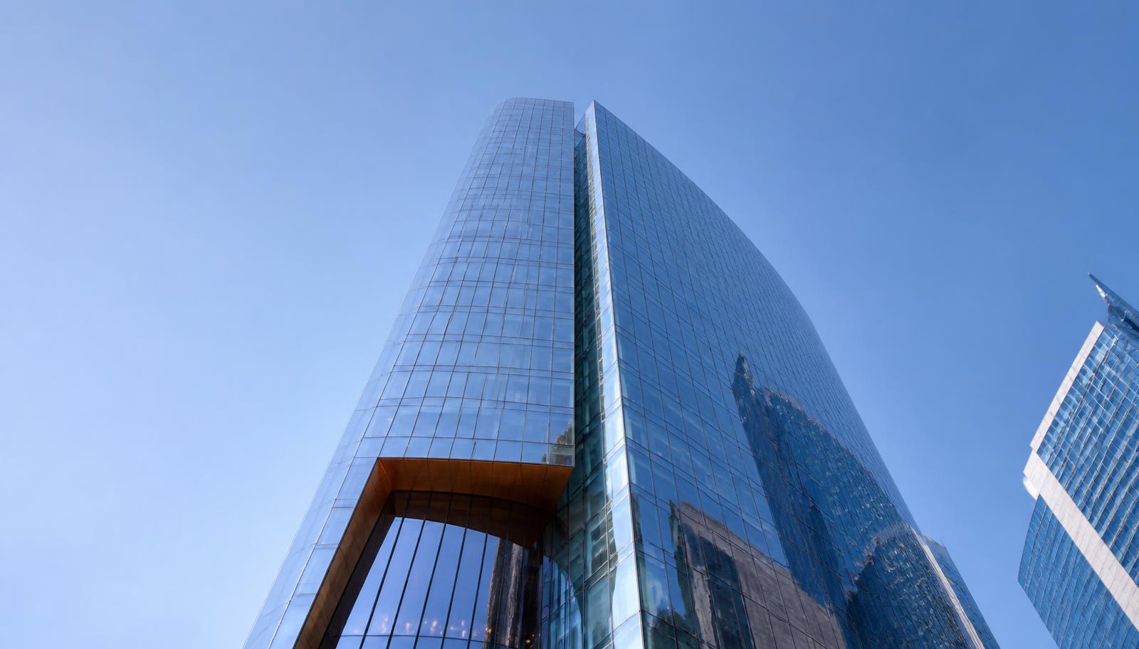 Low-angle view of a Dubai glass office tower
